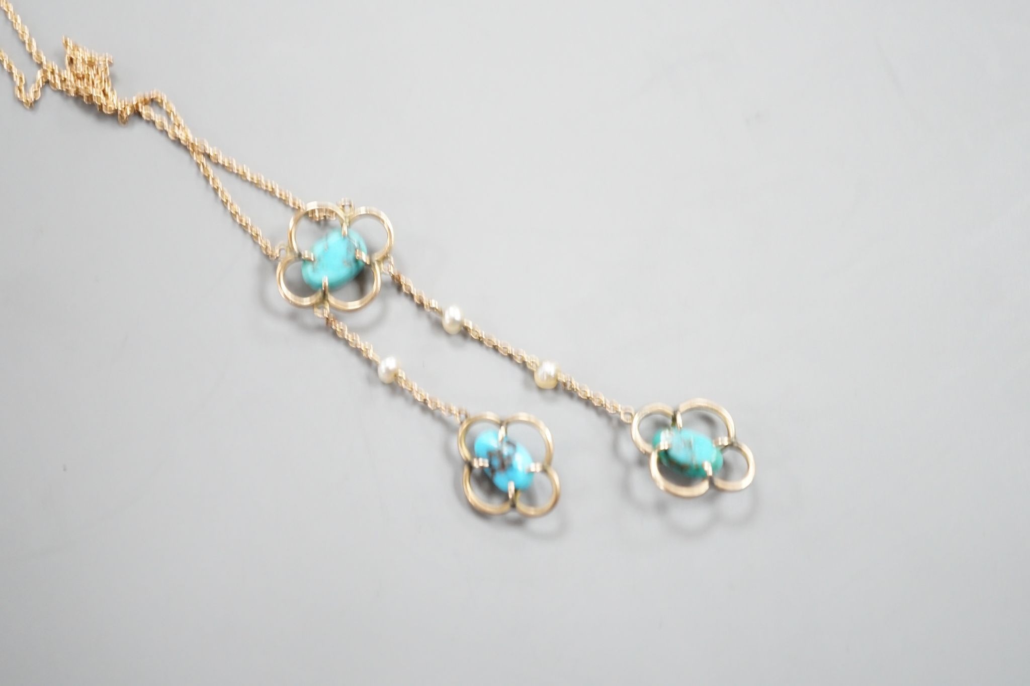 An Edwardian 9ct , three stone turquoise and three stone seed pearl set graduated double drop pendant necklace, 50cm, gross weight 3.1 grams.